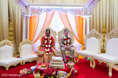 Indian couple seating under the mandap. indian wedding ceremony,indian bride and groom,floral and decor,mandap