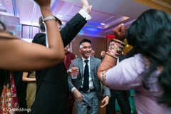 Guests having a good time in the dance floor indian wedding,indian wedding party,dj