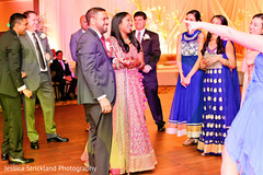 Indian bride and groom enjoying their wedding reception party indian bride reception fashion,indian wedding reception,indian groom suit,dj and entertainment
