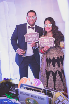 Indian couple having fun in the photo booth Indian couple having fun in the photo booth