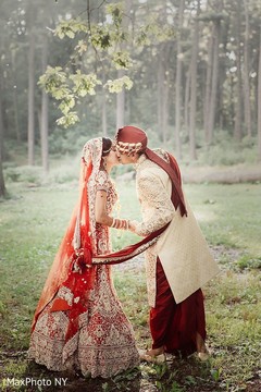 Adorable indian bride and groom kissing indian groom sherwani,indian bride lengha,outdoor photography