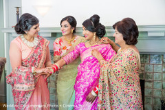 Indian bride getting help to get ready Indian bride getting help to get ready