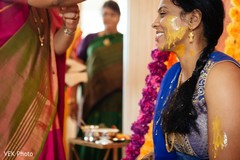 Indian wedding ritual of painting the bride with yellow turmeric paste pre- wedding celebrations,haldi ritual,haldi,indian bride