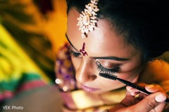 Lovely bride getting her makeup done indian bride,indian bride getting ready,bridal jewelry,indian bridal makeup