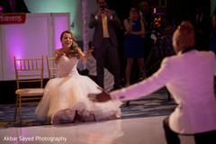 Sweet indian groom performing for bride indian wedding reception,indian bride and groom