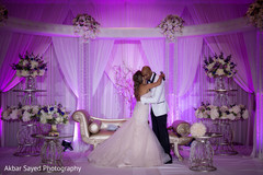 Sweet indian bride hugging groom indian wedding reception,indian bride and groom,lighting,indian wedding reception floral and decor