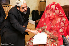 Pakistani bride signing the wedding contract. pakistani wedding photography,pakistani bride,nikaah