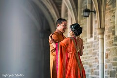 Indian bride and groom to be in matching orange outfits. Indian bride and groom to be in matching orange outfits.