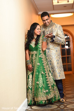Indian groom admiring bridal mehndi art Indian groom admiring bridal mehndi art