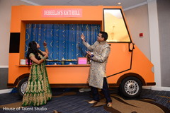 Indian bride and groom posing with sangeet food truck Indian bride and groom posing with sangeet food truck