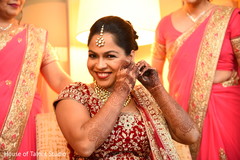 Beautiful indian bride putting earrings on indian bride fashion,indian bride getting ready,bridal jewelry,indian bridal mehndi