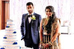 Cake cutting moment. indian wedding reception,wedding cake,indian bride and groom