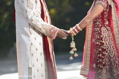 Charming indian couple holding hands first look photography,indian bride fashion,indian groom fashion,bridal jewelry