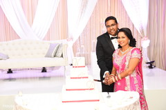 Phenomenal cutting the cake moment snap indian wedding reception,indian wedding cake,indian wedding cake design