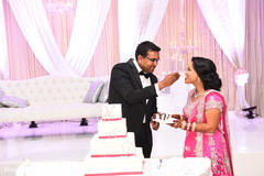 Indian bride tasting wedding cake indian wedding reception,indian wedding cake,indian wedding cake design,indian bride and groom