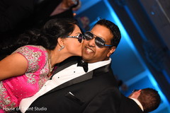 Adorable indian bride kissing groom's cheek indian bride fashion,indian groom fashion,indian wedding reception