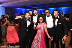 Indian bride and groom posing with groomsmen indian wedding reception,indian bride fashion,indian groom fashion