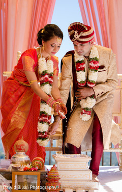 Sweet indian couple making offerings to sacred fire Sweet indian couple making offerings to sacred fire