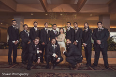 Indian bride and groom posing with groomsmen indian groom fashion,indian bride fashion,indian groomsmen fashion