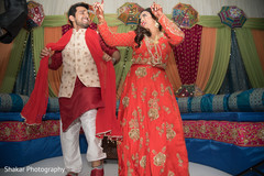 Indian couple dancing during sangeet Indian couple dancing during sangeet