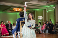 Indian bride holding her shoe up during wedding reception indian bride fashion,indian groom fashion,indian bride and groom,indian wedding reception
