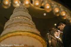 Indian bride and groom with cake capture indian wedding reception,indian wedding cake,indian wedding cake design