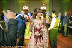 Joyful indian bride dancing during wedding reception party indian wedding reception,indian bride and groom,indian wedding reception photography,dj and entertainment