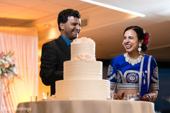 Adorable indian couple cutting the cake indian wedding reception,indian bride and groom,indian wedding cake