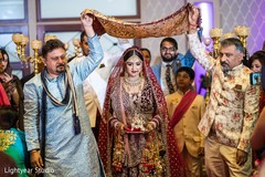 Indian bride walking down the aisle under a canopy. Indian bride walking down the aisle under a canopy.