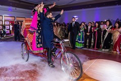 Ecstatic Indian bride and groom entrance. indian bride and groom,indian wedding reception,rickshaw