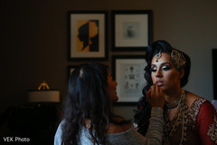Lovely bride getting her makeup done indian bride,indian bride getting ready,bridal jewelry,indian bridal makeup