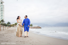 Lovely indian couple walking by the beach Lovely indian couple walking by the beach
