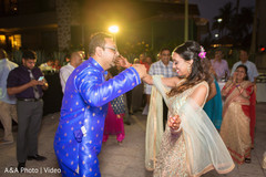 Indian bride and groom dancing during sangeet night Indian bride and groom dancing during sangeet night