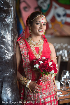 Dazzling indian bride posing bridal jewelry,indian bride lengha,indian bridal bouquet