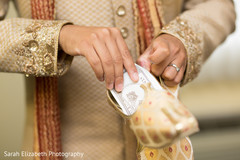 Indian groom holding his juttis Indian groom holding his juttis