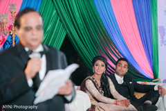 Indian couple listening one of their wedding speeches Indian couple listening one of their wedding speeches