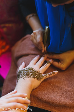 Henna artist making bridal mehndi art pre- wedding celebrations,mehndi art,mehndi artist