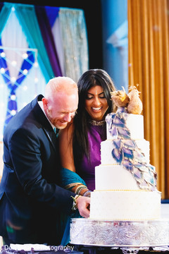 Indian couple cutting the wedding cake Indian couple cutting the wedding cake