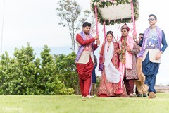 Unique bride and groom entering under a canopy. destination wedding,indian wedding ceremony,indian bride and groom
