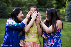 Indian bride having fun with her mother and sister blue sari,colorful sari