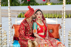 Indian newlyweds posing at a traditional swing. indian wedding photography,indian bride and groom,swing