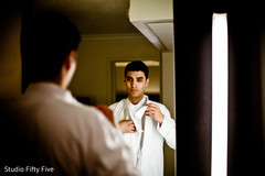 Indian groom preparing his wedding outfit. indian groom,getting ready,indian groom fashion