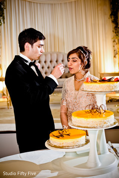 Sweet Indian wedding cake cutting moment.. indian wedding reception,indian wedding cake,indian bride and groom