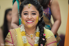 Indian bride is smeared in yellow turmeric paste at her first wedding ceremony ritual pre- wedding celebrations,indian bride fashion,haldi ceremony
