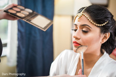 Beautiful indian bride being dolled up for her ceremony indian bride getting ready,indian bride hair and makeup,bridal jewelry