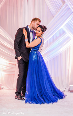 Cute indian groom kissing bride's forehead indian groom fashion,indian bride fashion,indian wedding reception