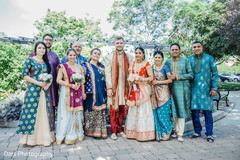 Adorable indian couple posing with their family indian groom fashion,indian bride fashion,indian bride and groom portrait