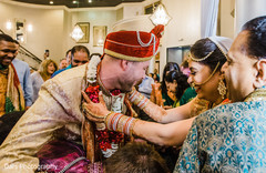 Sweet indian couple during milni ritual indian groom fashion,indian wedding ceremony,milni ceremony