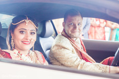 Lovely indian couple on wedding car leaving wedding venue bridal jewelry,indian bride and groom