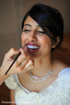 Charming maharani getting ready for her big day. indian bride,getting ready,white sari,hair and makeup